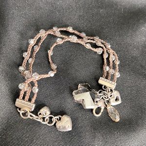 Brighton multi strand, brown cord with clear beads sewn in . Cross pendant